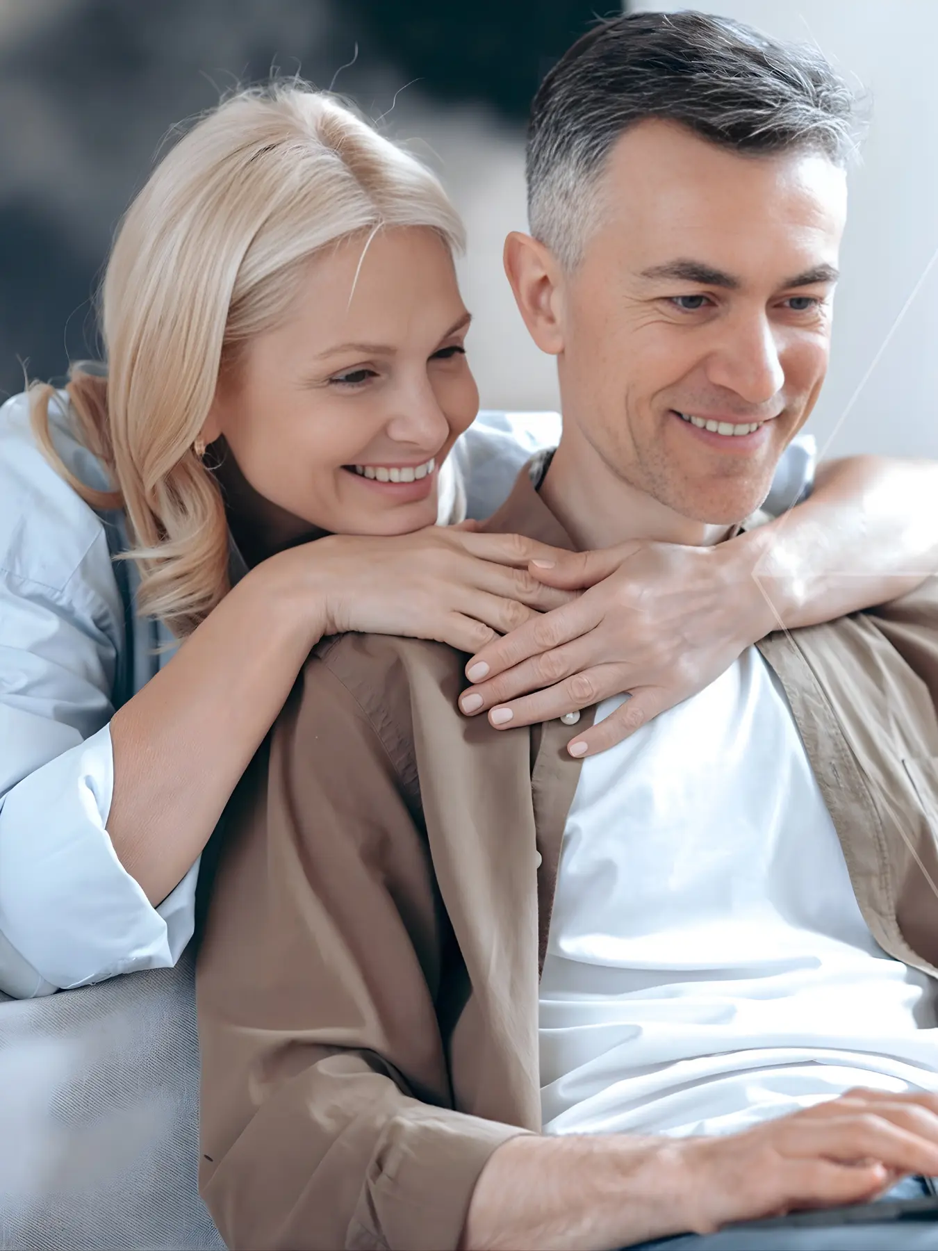 A couple reviewing their early retirement planning strategy on a laptop comfortably at home.