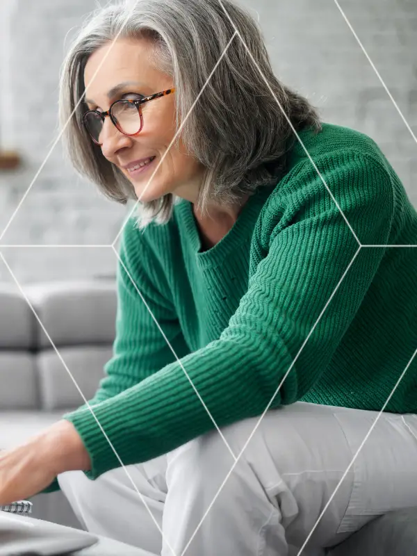 Financial advisor reviewing tax strategies for high net worth clients while taking notes beside a laptop.